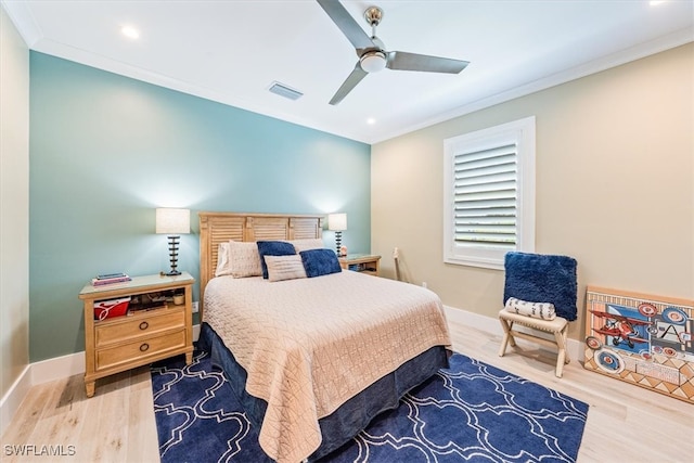 bedroom featuring ornamental molding, hardwood / wood-style floors, and ceiling fan