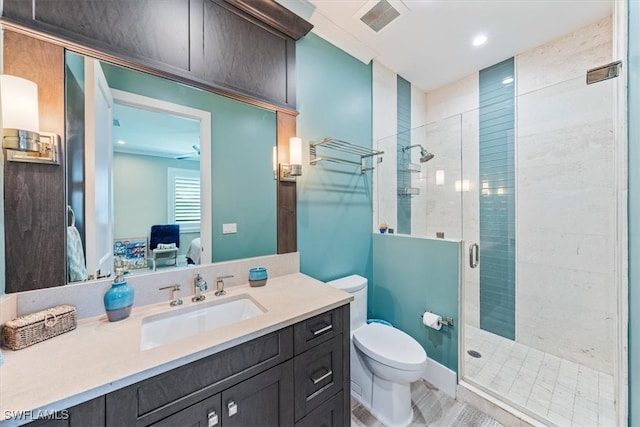 bathroom featuring an enclosed shower, vanity, and toilet