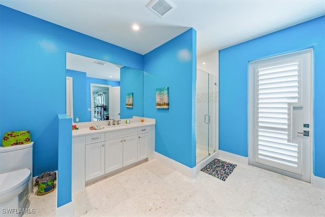 bathroom featuring walk in shower, vanity, and toilet