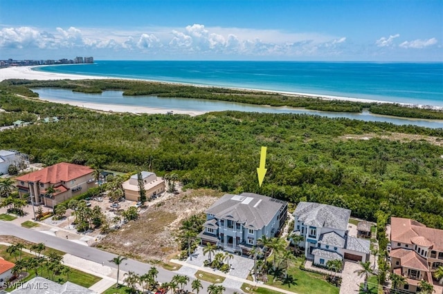 birds eye view of property featuring a view of the beach and a water view