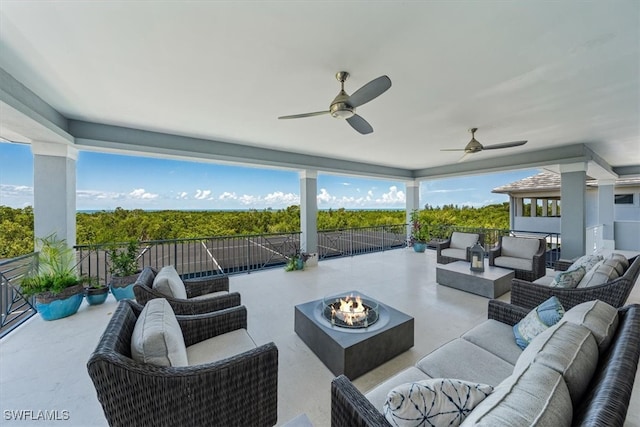 view of patio featuring an outdoor living space with a fire pit and ceiling fan