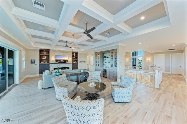 living room featuring a fireplace, plenty of natural light, and light hardwood / wood-style flooring