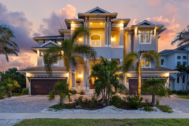 view of front of home with a garage and a balcony