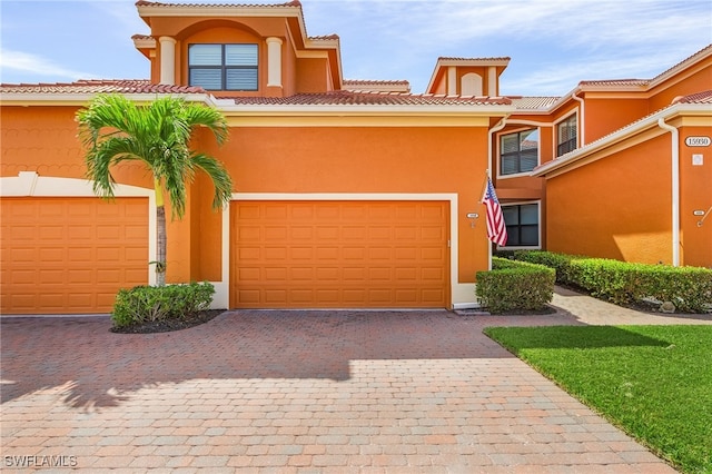 mediterranean / spanish-style home with a garage