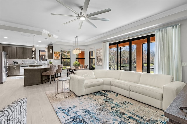 living room featuring ceiling fan and ornamental molding