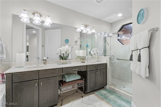 bathroom with vanity, a shower with shower door, and tile patterned flooring