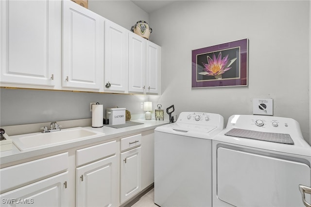 washroom with cabinets, sink, and separate washer and dryer