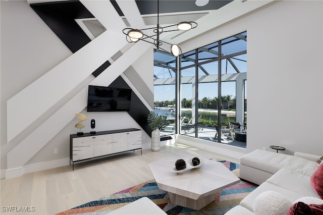 living room with light hardwood / wood-style flooring and a notable chandelier