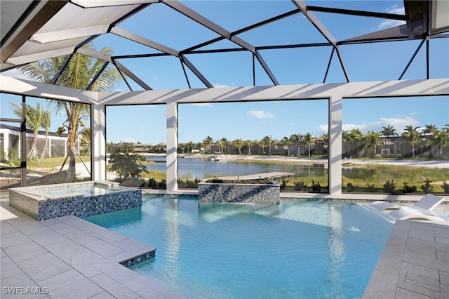 view of pool featuring a patio, an in ground hot tub, a water view, and glass enclosure