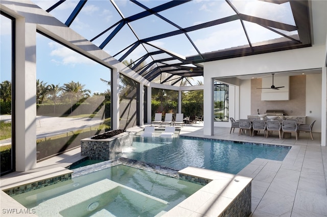 view of pool featuring an in ground hot tub, pool water feature, a lanai, a patio area, and ceiling fan