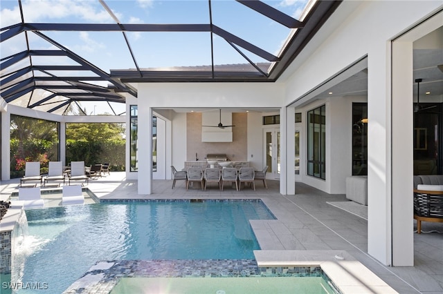 view of swimming pool with a patio, a lanai, a grill, and pool water feature