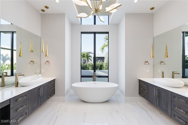 bathroom with vanity, a tub, and plenty of natural light