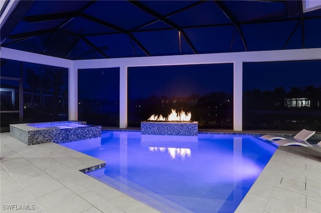 pool at night with an in ground hot tub