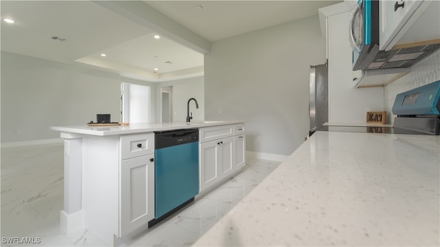 kitchen with white cabinets, a center island with sink, appliances with stainless steel finishes, light stone countertops, and sink