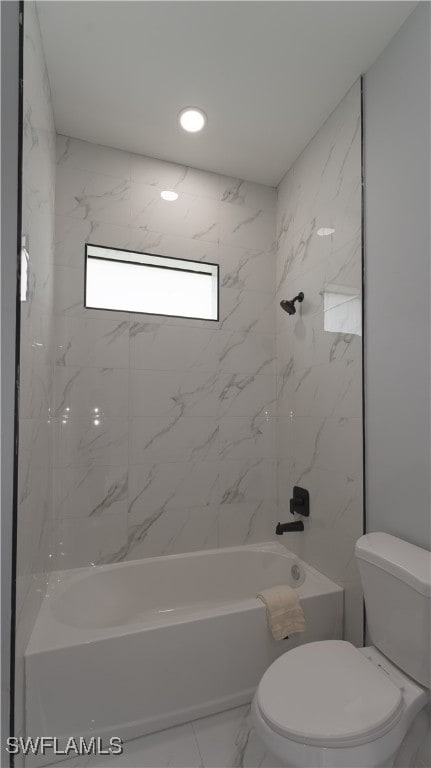 bathroom featuring toilet and tiled shower / bath combo