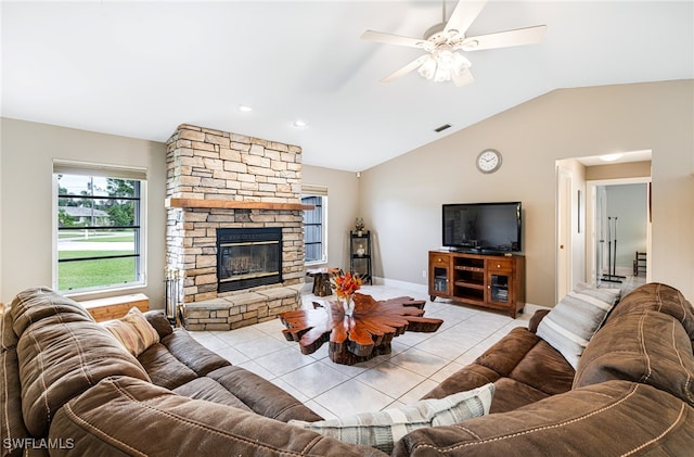 tiled living room with vaulted ceiling, a fireplace, and ceiling fan