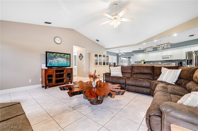 tiled living room with ceiling fan and vaulted ceiling