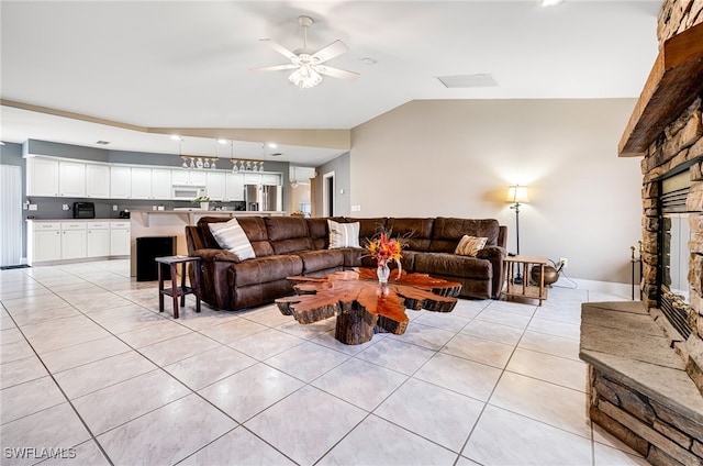 tiled living room featuring lofted ceiling, a fireplace, and ceiling fan