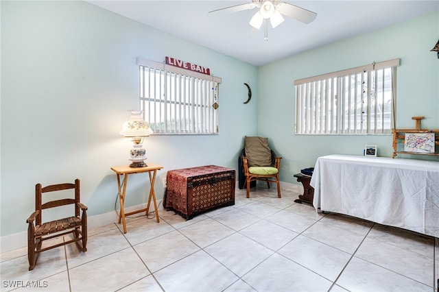 bedroom with ceiling fan, light tile patterned flooring, and multiple windows