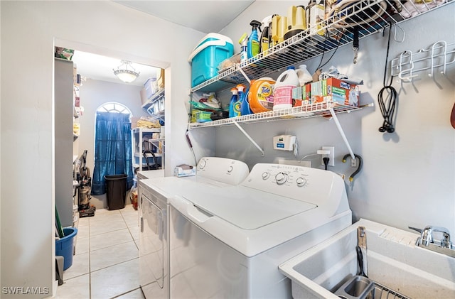 laundry room with sink, tile patterned flooring, and washing machine and clothes dryer