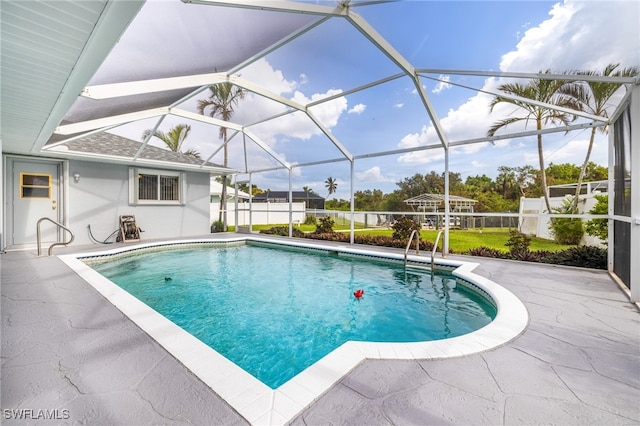 view of swimming pool with a patio and a lanai