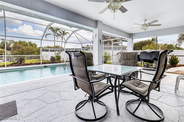 view of patio featuring a fenced in pool, glass enclosure, and ceiling fan