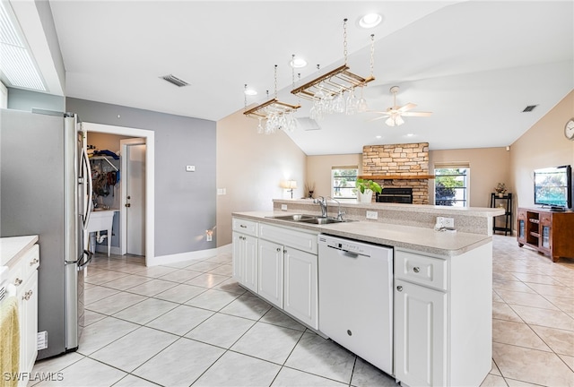 kitchen featuring white dishwasher, sink, white cabinetry, and a center island with sink