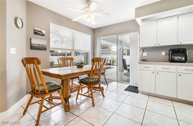 tiled dining room featuring ceiling fan and a healthy amount of sunlight