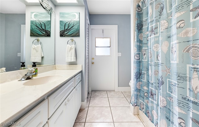 bathroom with vanity, toilet, and tile patterned flooring