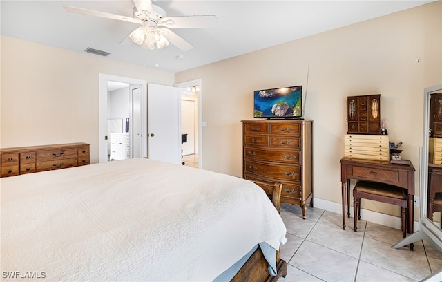 bedroom with ensuite bath, light tile patterned flooring, and ceiling fan