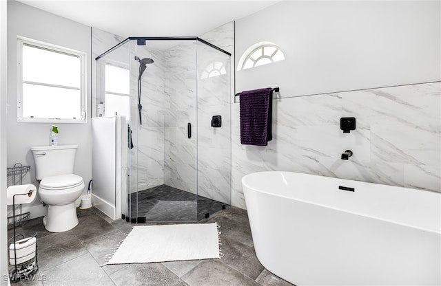 bathroom featuring toilet and separate shower and tub