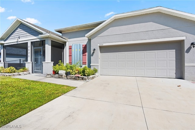 view of front of home with a front yard and a garage