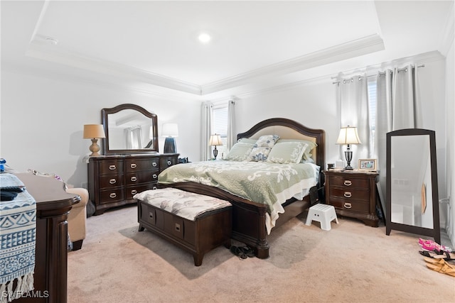 carpeted bedroom with crown molding and a raised ceiling