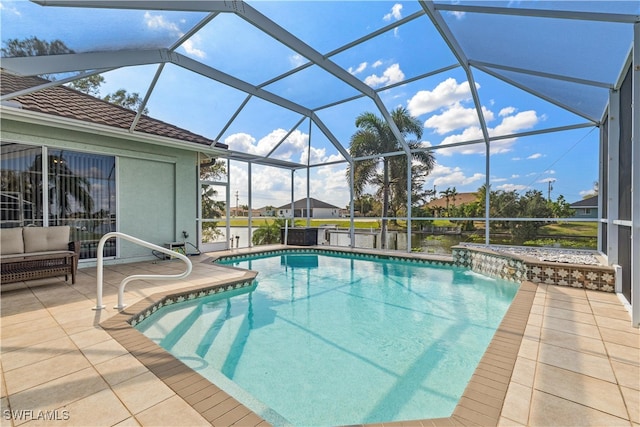 view of pool with pool water feature, a patio area, and a lanai