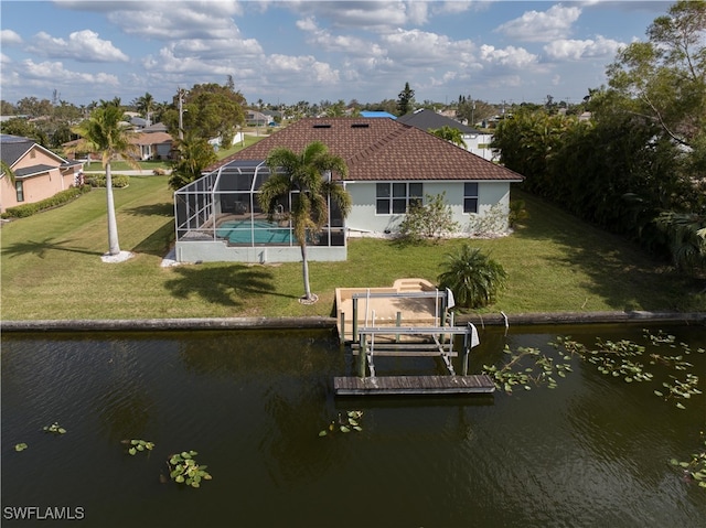 view of dock featuring a yard, a water view, and glass enclosure