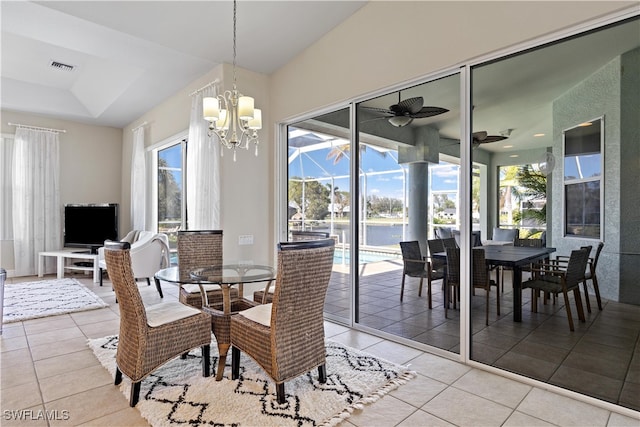 dining area featuring ceiling fan with notable chandelier and light tile patterned floors