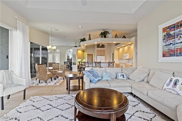 tiled living room featuring a chandelier