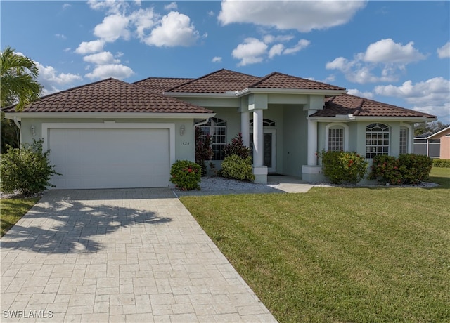 mediterranean / spanish house with a front yard and a garage