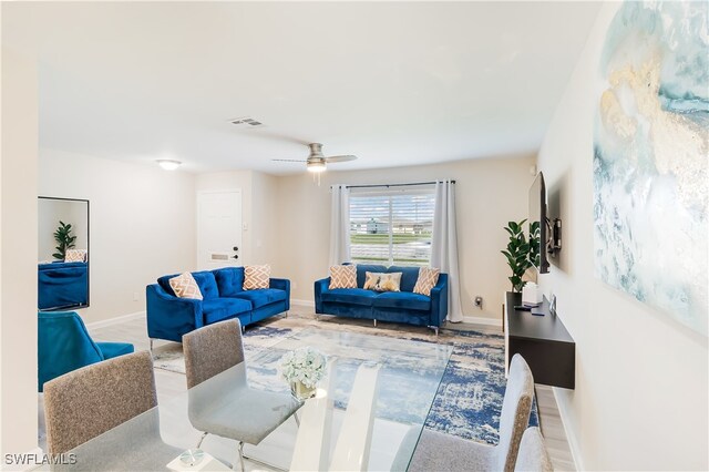 living room with ceiling fan and light wood-type flooring