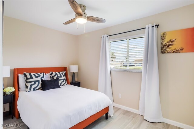 bedroom with light hardwood / wood-style floors and ceiling fan