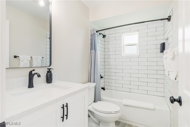 full bathroom featuring vanity, toilet, and shower / bathtub combination with curtain