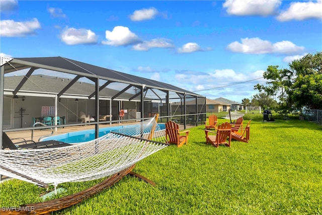 view of pool featuring a yard, a patio area, and a lanai