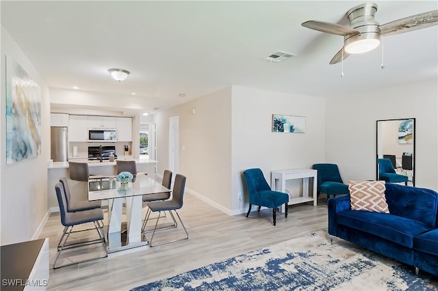 dining space with light wood finished floors, baseboards, ceiling fan, and recessed lighting