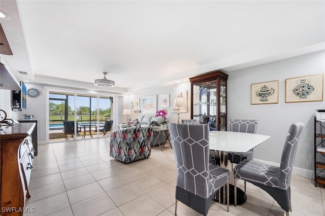 190 Pebble Beach Blvd Unit 103, Naples, FL 34113 - dining space with light tile patterned flooring and baseboards
