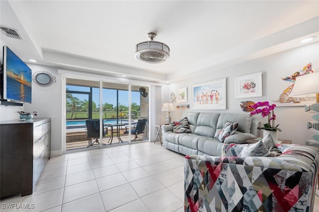 190 Pebble Beach Blvd Unit 103, Naples, FL 34113 - living area featuring light tile patterned floors, recessed lighting, and a tray ceiling