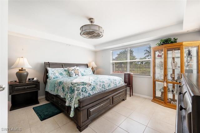 190 Pebble Beach Blvd Unit 103, Naples, FL 34113 - bedroom with light tile patterned flooring, baseboards, and a raised ceiling