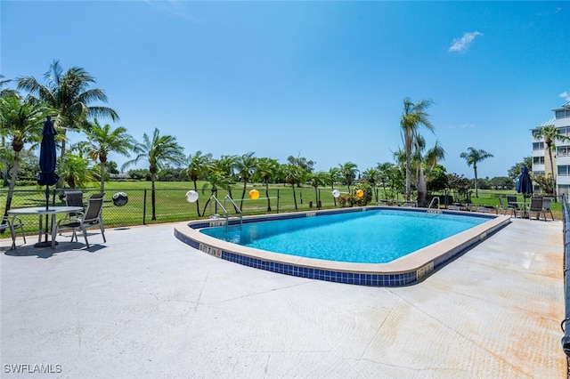 190 Pebble Beach Blvd Unit 103, Naples, FL 34113 - community pool with fence and a patio
