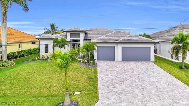 view of front of home with a front yard and a garage