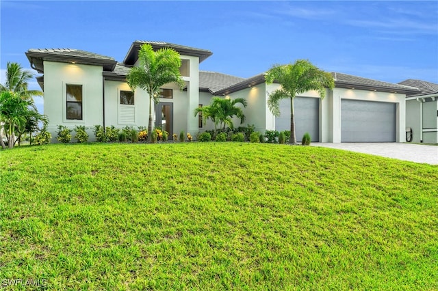 view of front of home featuring a front lawn and a garage