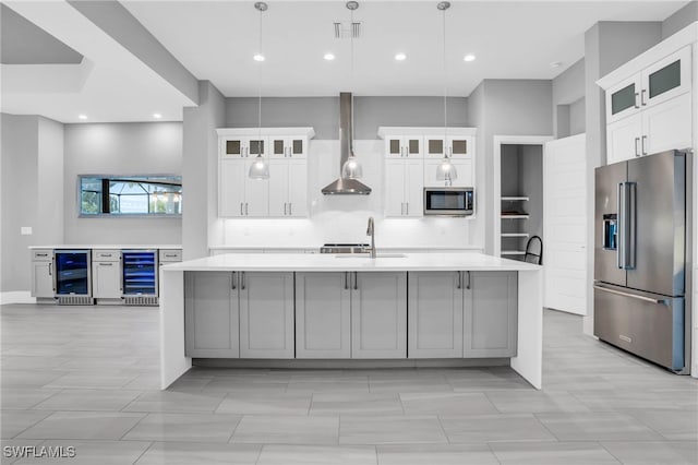 kitchen featuring wine cooler, a spacious island, pendant lighting, and stainless steel appliances